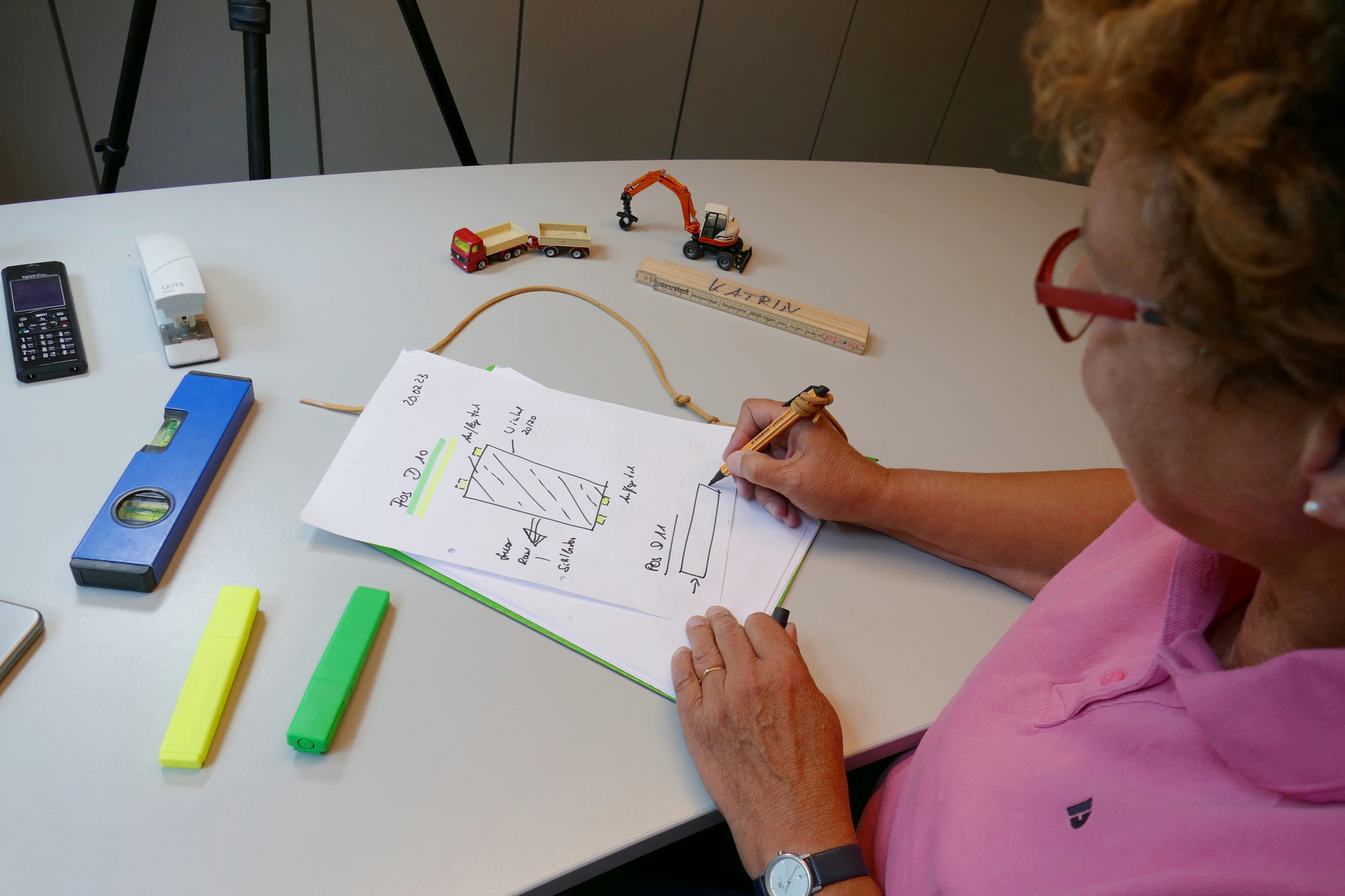 A woman draws construction plan